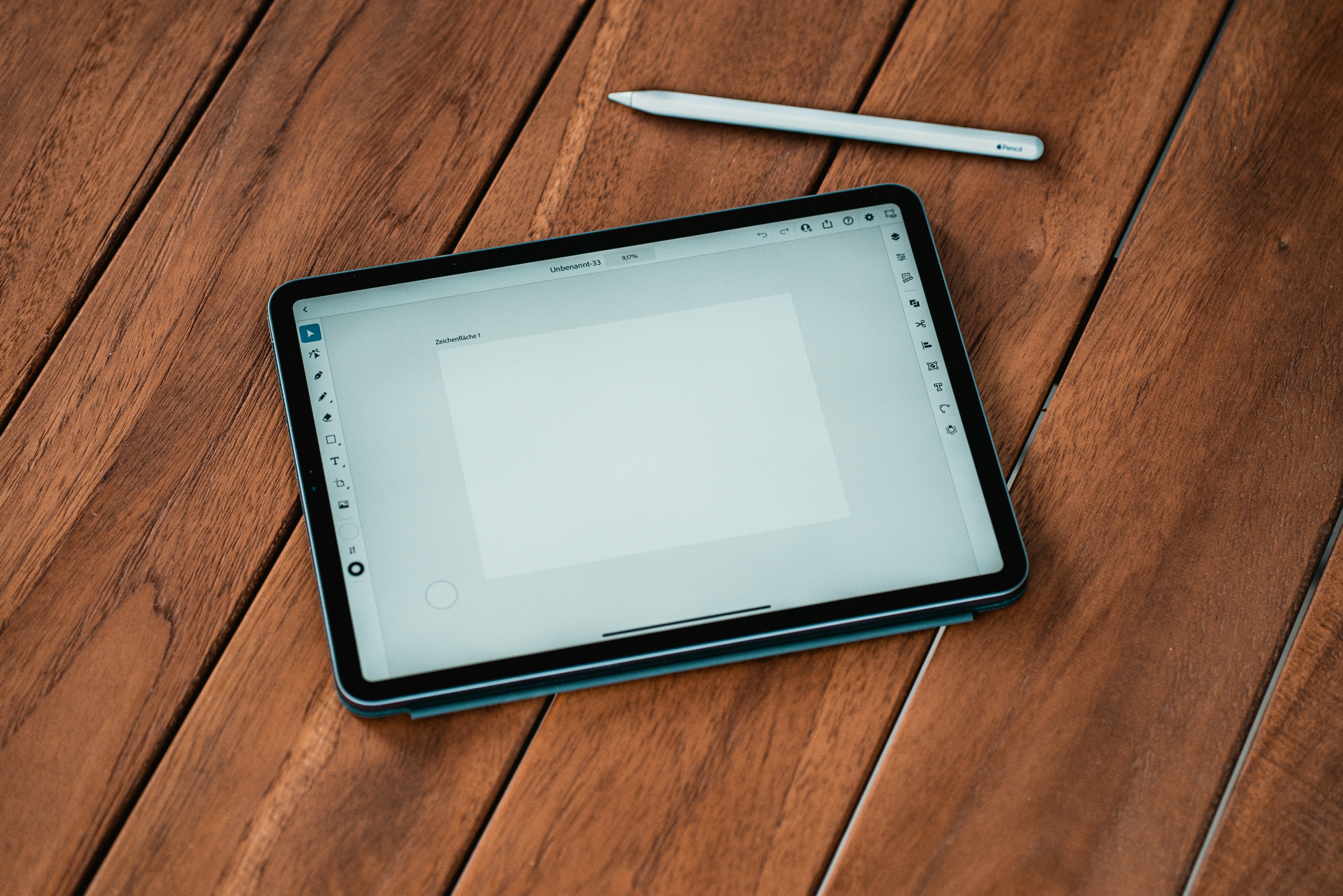 black ipad on brown wooden table